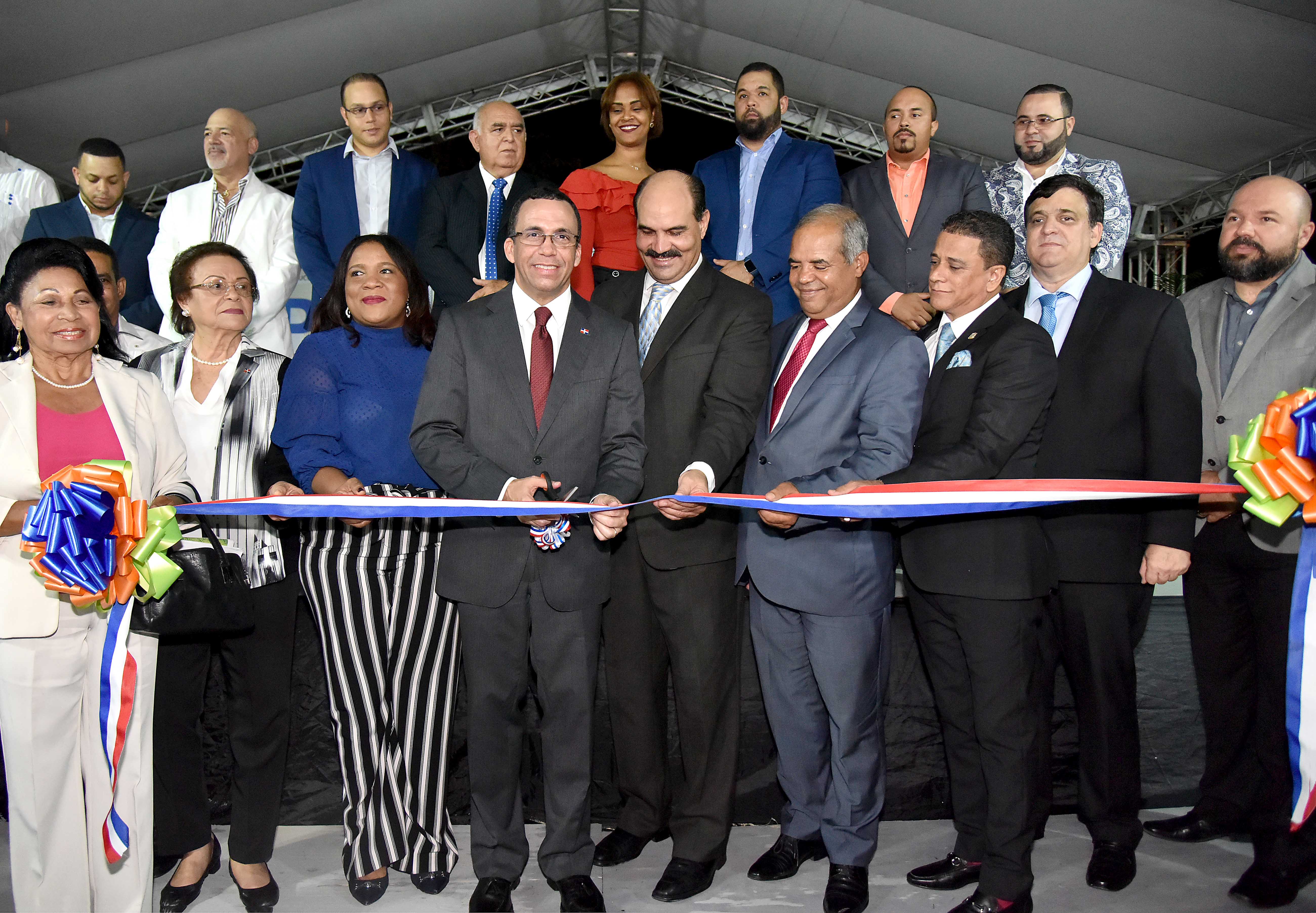 imagen Ministro Andrés Navarro de pie conrtando cinta  en la apertura de la XX Expo Bonao 2018 junto a autoridades de la provincia Monseñor Nouel 